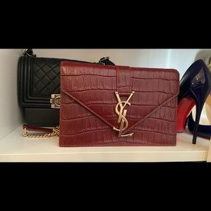 YSL burgundy bag.